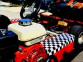 Close-up view of red and white gokart with black and white checkered pattern
