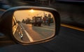 A close-up view, the reflection of the car`s side mirrors with the early morning orange sun rising
