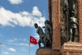 Close up view of the republic monument located at Taksim square and Turkish flag in Istanbul.