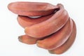 Close up view of ripe tropical tasty red bananas isolated on white.