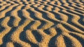 Rippled sand patterns formed by wind showcasing alternating ridges and Royalty Free Stock Photo