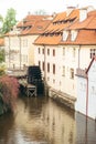 Close-up view of the river port near surrounded by old buildings and colourful trees. Prague location.