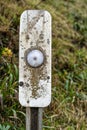 A close up view of a roadside reflector on a post