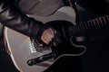 Close-up view of rock musician mans hands masterfully playing electric guitar. Fingers tapping strings in smoky Royalty Free Stock Photo