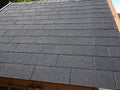 Close up view of a roof with bitumen shingles