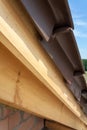 Close-up view of roof detail with wooden rafters and roof tiles. New house under construction. Royalty Free Stock Photo