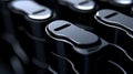 A close-up view of a row of black rectangular objects with silver edges, arranged in a slightly overlapping pattern. Royalty Free Stock Photo