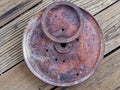 Close up view of a rusty disc with a metal ring on top