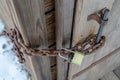 Close up view of rusty iron metal chain with gold plated combination padlock Royalty Free Stock Photo