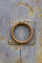 Close-up view of rusty knocker on a rusty metal door. The texture of metal and rust is visible. Georgia Royalty Free Stock Photo