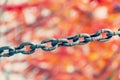 Close up view of rusty metal chain links on a blurred multicolored background Royalty Free Stock Photo