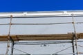 Close up view of rusty metal scaffolding with working wooden platform