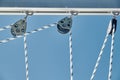 Close-up view of sailboat ropes at sunny weather, pulleys and ropes on the mast, Yachting sport, ship equipment, sea is Royalty Free Stock Photo