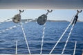 Close-up view of sailboat ropes at sunny weather, pulleys and ropes on the mast, Yachting sport, ship equipment, sea is