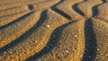 Close up view of sand with wavy patterns creating a textured Royalty Free Stock Photo
