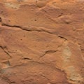 Close-up view of a sandstone surface with a reddish-brown hue. The stone exhibits a Royalty Free Stock Photo