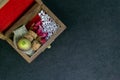 Close up view of scattered homeopathic pills with pink flowers, wild fruit, bottleÃ¢â¬â¢s cork and burlap in wooden old box on dark Royalty Free Stock Photo