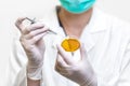 Close up view of scientist with Petri dish and pipette. Biological Experiment in laboratory.