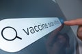 Close-up view of searching information about COVID vaccine side effects Royalty Free Stock Photo