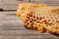Section of wax honeycomb from beehive on the vintage wooden back Royalty Free Stock Photo