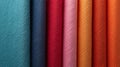 Close-up view of a selection of multi-colored textured fabric swatches arranged vertically Royalty Free Stock Photo