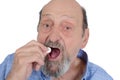 Close up view of senior man taking pill Royalty Free Stock Photo