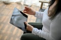 Close up view of senior woman using tablet while sitting on the sofa Royalty Free Stock Photo