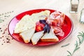 Close up view on served Italian breakfast with scrambled eggs, prosciutto, baguette, basil and cherry tomatoes. Royalty Free Stock Photo