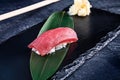 Close up view on served Nigiri with tuna on dark plate on dark background with copy space. Delicious salmon Nigiri Sushi. Royalty Free Stock Photo