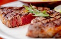 Close up view on serving of marinated grilled rib eye steak with baked potatoes and vegetables Royalty Free Stock Photo