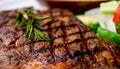 Close up view on serving of marinated grilled rib eye steak with baked potatoes and vegetables Royalty Free Stock Photo