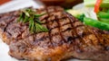 Close up view on serving of marinated grilled rib eye steak with baked potatoes and vegetables Royalty Free Stock Photo