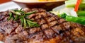 Close up view on serving of marinated grilled rib eye steak with baked potatoes and vegetables Royalty Free Stock Photo