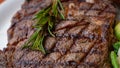 Close up view on serving of marinated grilled rib eye steak with baked potatoes and vegetables Royalty Free Stock Photo