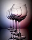 Close up view of several aligned empty glasses of wine on neon background