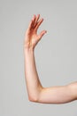 Close-Up of a Human Arm Extended Against a Plain Background Royalty Free Stock Photo