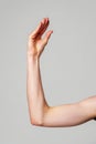 Close-Up of a Human Arm Extended Against a Plain Background Royalty Free Stock Photo