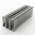 Stack of Metal Staples in a Rectangular Tray on a White Surface stationery office supplies Royalty Free Stock Photo