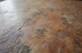 Close up view shows old rustic kitchen worktop surface texture. Worn brown, grey granite concrete material displays rough grunge Royalty Free Stock Photo