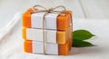 Stack of three handmade soaps tied with twine and decorated with labels and green leaves Royalty Free Stock Photo