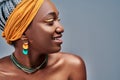 Close up view side portrait of beautiful black woman smiling against grey background Royalty Free Stock Photo