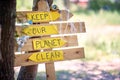 Close-up view on the sign with ecological slogans in the forest. Ecology, people, care