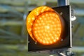 Close up view: signal LED orange traffic light blinking at transport exhibition