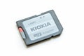 Close-up view of a simple Kioxia brand microSD to SD card adapter object isolated on a white background, memory storage data card Royalty Free Stock Photo