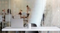 Close up view of workspace with blank screen laptop, coffee cup and copy space on white table with blurred office room Royalty Free Stock Photo