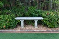 Close up view of single ancient stone or concrete bench in garden sideways