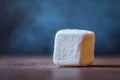Close-Up View of a Single Sugar Cube on Wooden Table with Background Royalty Free Stock Photo