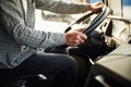 Close up view, sitting inside. Young truck driver in casual clothes