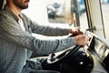 Close up view, sitting inside. Young truck driver in casual clothes