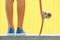 Close up view of skateboarder legs, sneakers, skateboard